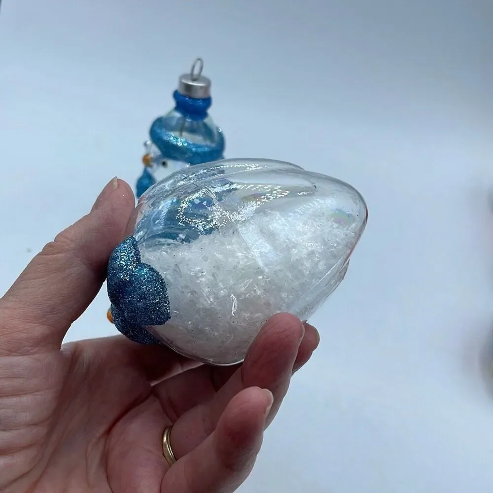 Lot of 2 glass chickadee ornaments with scarves and hats. Faux snow in bottoms.
